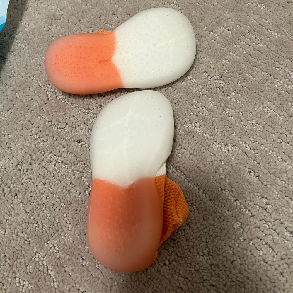 2 Tiny Feet baby walker shoes, never been worn. Orange and white